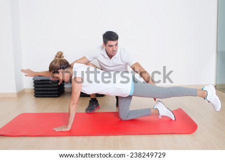 coach showing flexibility exercise to an elder woman