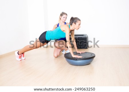 sporty woman in gym with female coach