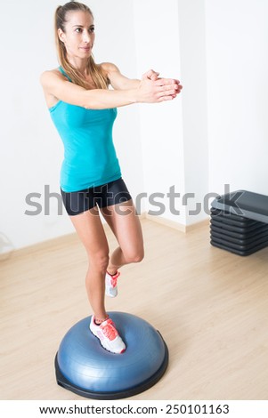 woman doing balance training on platform side down