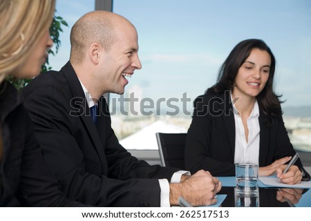 Three persons having fun during brainstorming in blackroom
