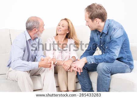 Elderly son talking with his parents