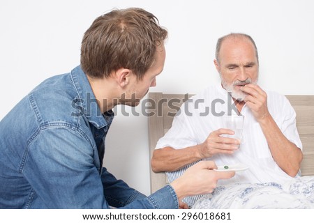 Giving medication to an elderly man