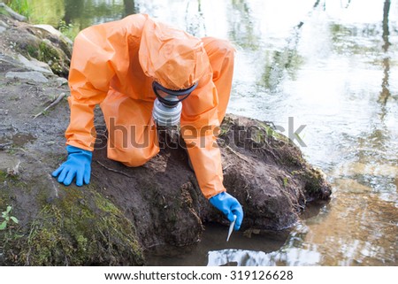 Woman performing water sampling and analysis outside