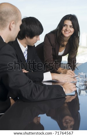 Business team of three persons relaxed at the table