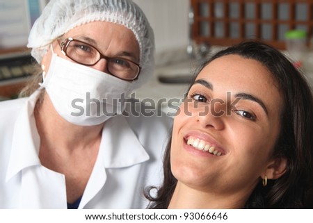 Happy female patient with dentist