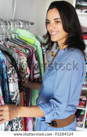 Beautiful latin woman in a store looking for clothes