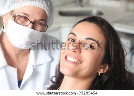Happy female patient with dentist
