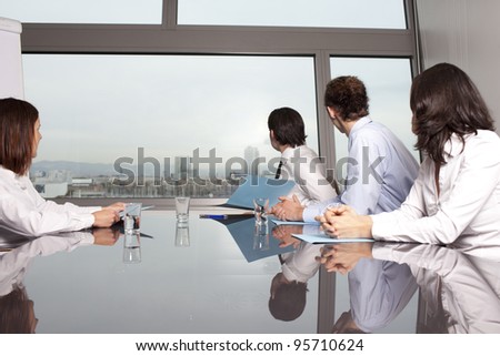 Group of real estate agents showing city from office