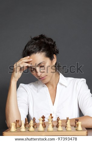 Business woman over a chess game