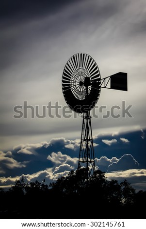 silhouette of wind mill weather vane