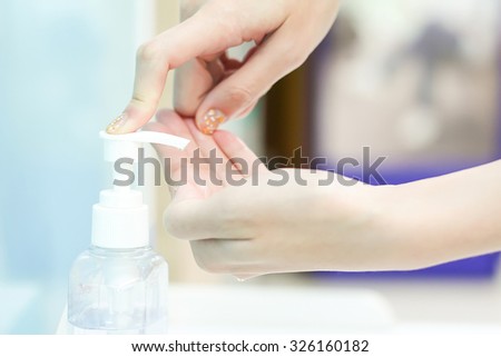 woman hand using sanitizer gel at hospital