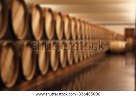 blurry image of wine barrel in cellar