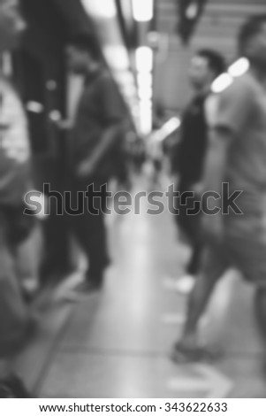 blurry image of passenger boarding train, monochrome