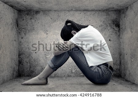 crying girl hug her knee and sitting alone in empty room
