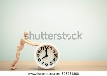 human wooden dummy with alarm clock at 8 o\'clock in the morning