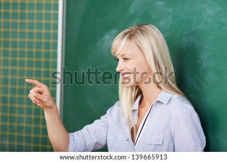 Laughing woman pointing at something while presenting on the board