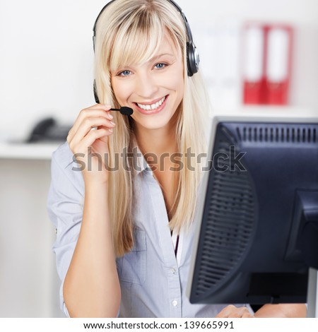 Blond call center operator smiling and answering call
