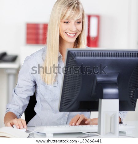 Young woman working on the desktop inside the office