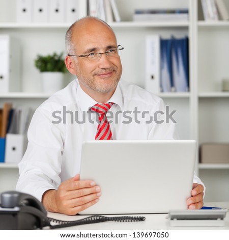 happy businessman at work with laptop