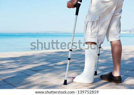 An Injured man with a plaster on the beach