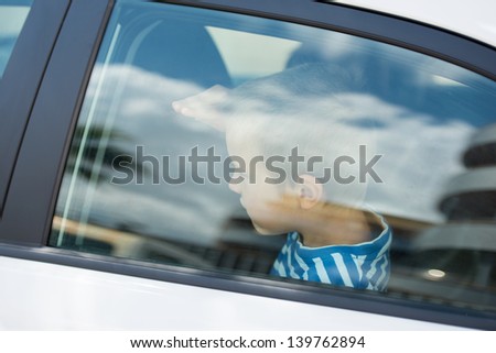 Close up portrait of little guy inside the car