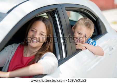 Mother and child waiting for something inside the car
