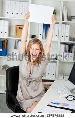 Laughing mid adult businesswoman holding blank paper