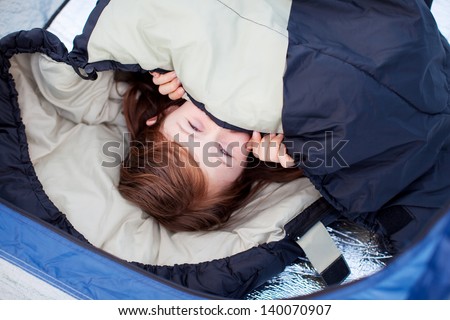 Portrait Of Little Girl Lying In Sleeping Bag