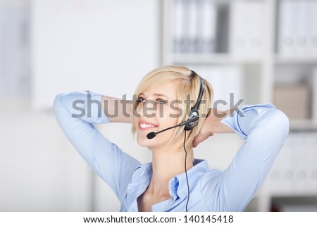 relaxed businesswoman wearing headset in the office