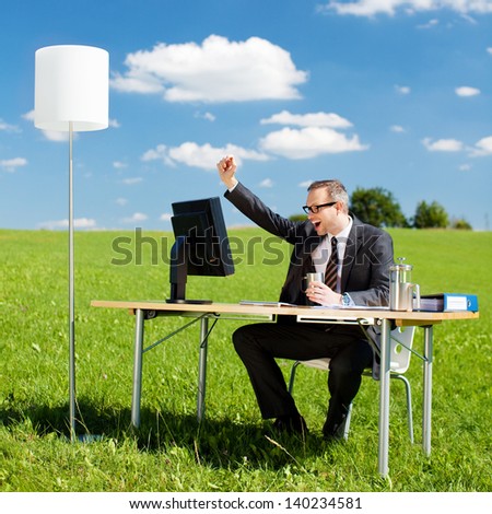 Successful businessman raising his hand in the office outdoors