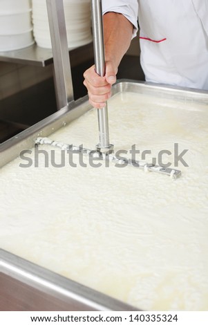 Freshly fermented cheese being moved on during production process