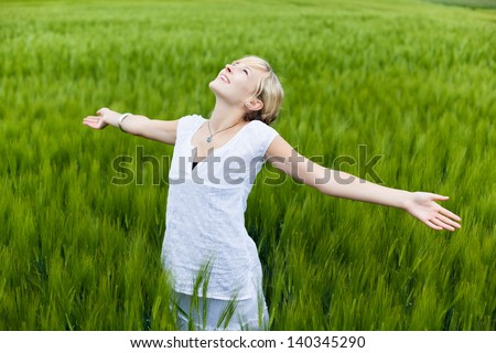 young woman in nature with arm extended