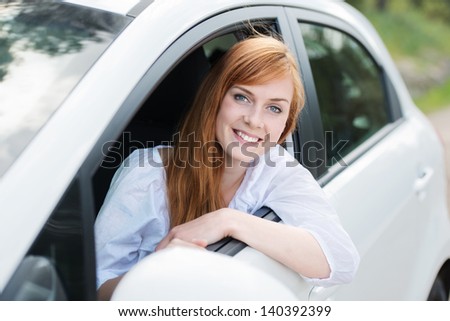 Smiling female driver looking out the car