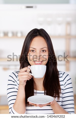 modern woman drinking a cup of coffee at home