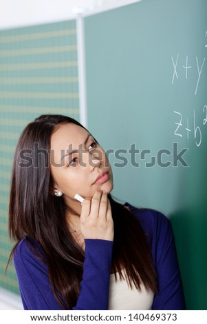 student looking at board, thinking about maths formula