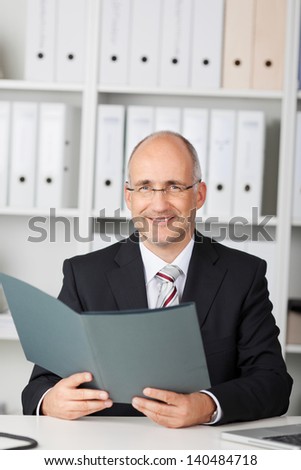 confident businessman reading cv in the office