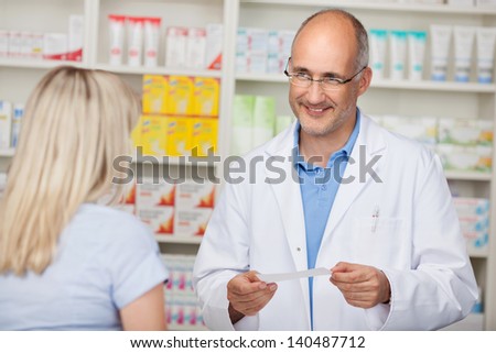 confident mature pharmacist in customer interview with woman
