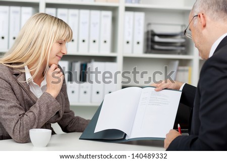 businesspeople in an interview looking at cv
