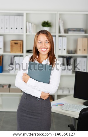 Young businesswoman with a curriculum vitae in her arms, looking for a job