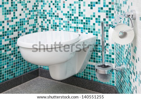 Toilet seat and paper in clean bathroom