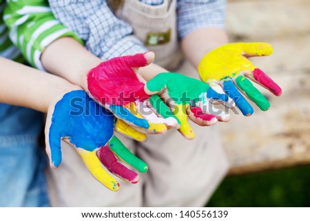 Creative children showing their colorful painted hands