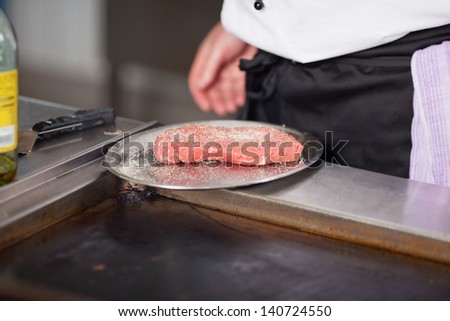 cook with raw meat in restaurantÃ?Â´s kitchen