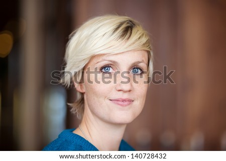Closeup portrait of young female customer smiling in restaurant