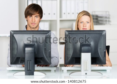 business man and woman working on computers in the office