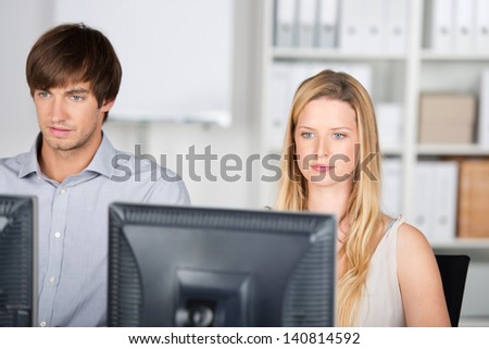 business man and woman working on computers