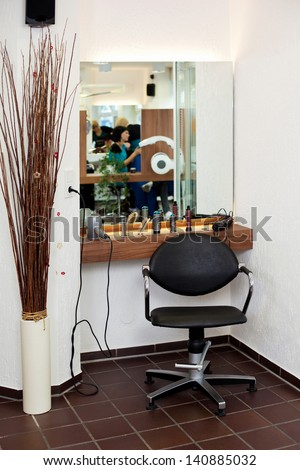 Interior of salon with chair; counter and reflection on mirror
