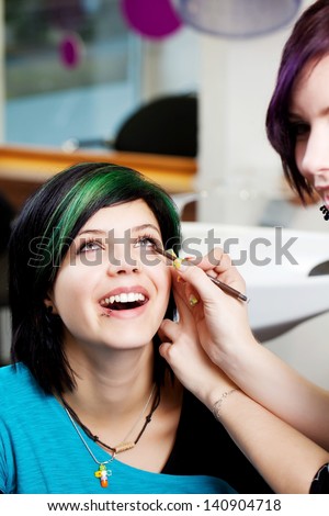 Closeup of salon worker applying kajal on woman\'s eye