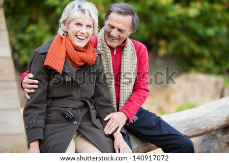 Portrait of sweet senior couple talking and laughing at the park