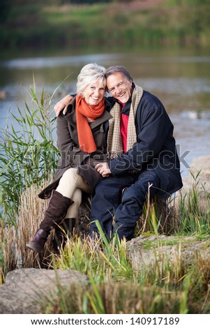 A happy senior couple enjoying at the lake