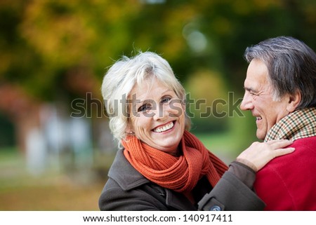 A happy senior couple enjoying a moment of love in the forest
